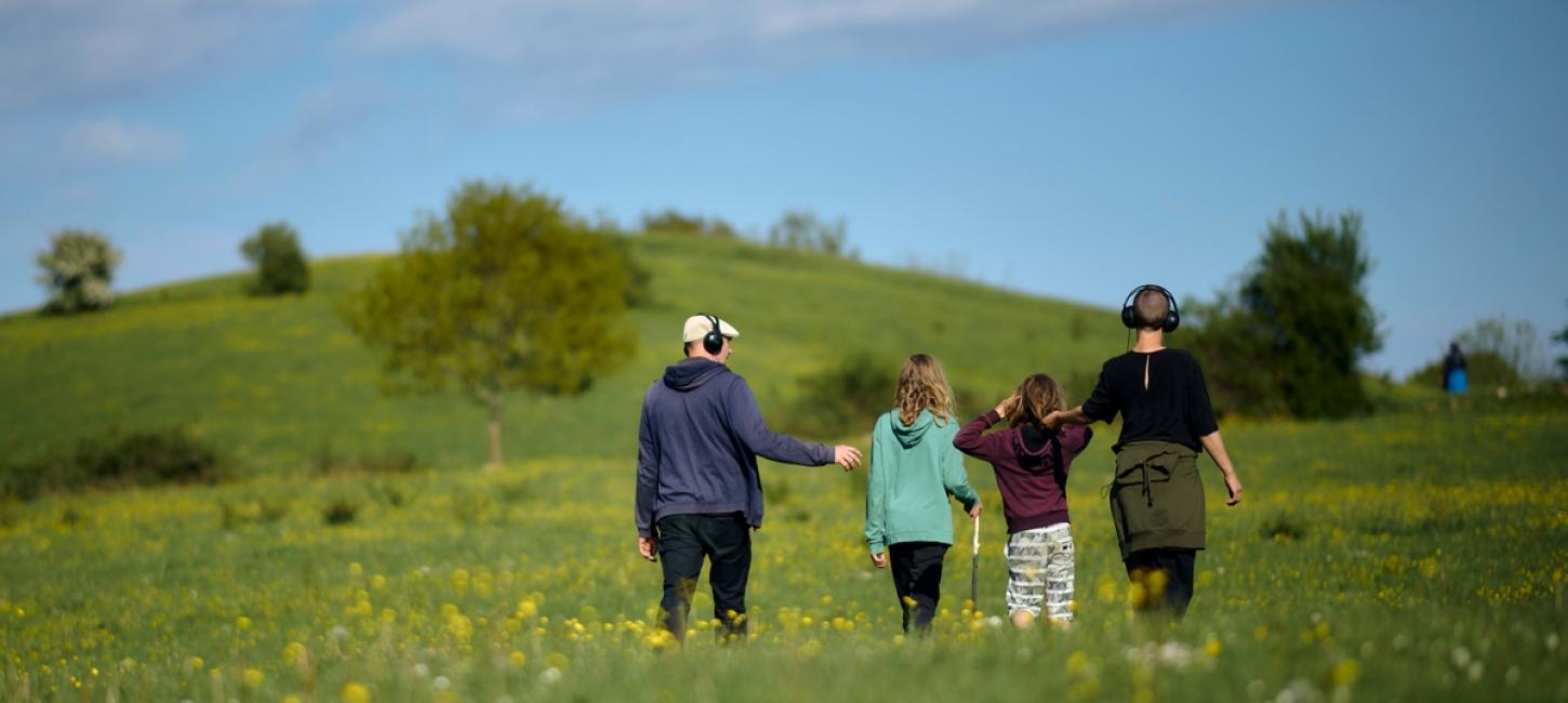 Billede af en familie der går lydfortællingen "Mod strømmen"